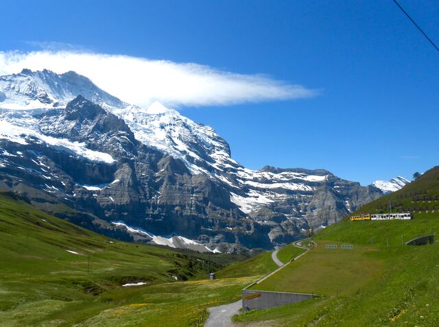 View from the start of the Jungfrau Railway. The Wengernalp Railway’s green and yellow train is visible in the background.