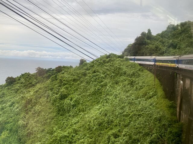 Train travelling across a viaduct adjacent to the South China Sea